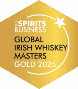 A gold hexagonal award badge from The Spirits Business for the Global Irish Whiskey Masters Gold 2025, featuring a white star and swoosh graphic.